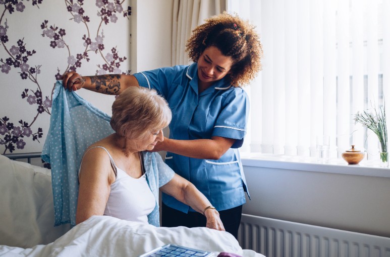 home caregiver helping senior patient get dressed in ocean county nj