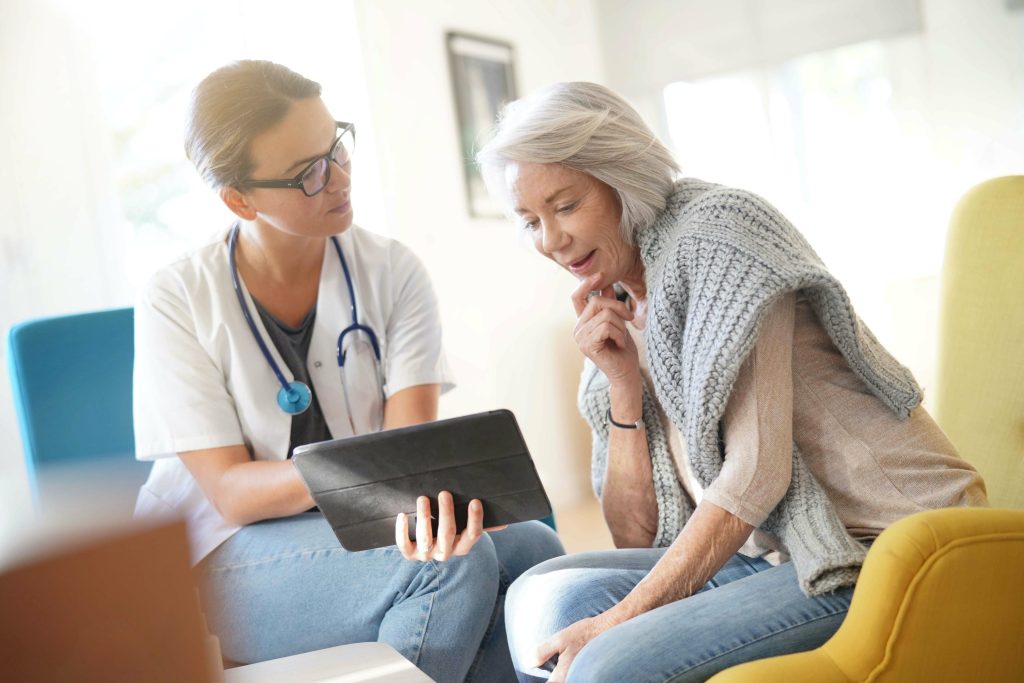 home care provider new jersey florida reviewing medication on tablet with senior patient