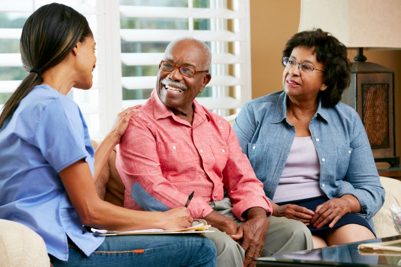 A live-in caregiver talks to a senior couple in their New Jersey or Florida home.