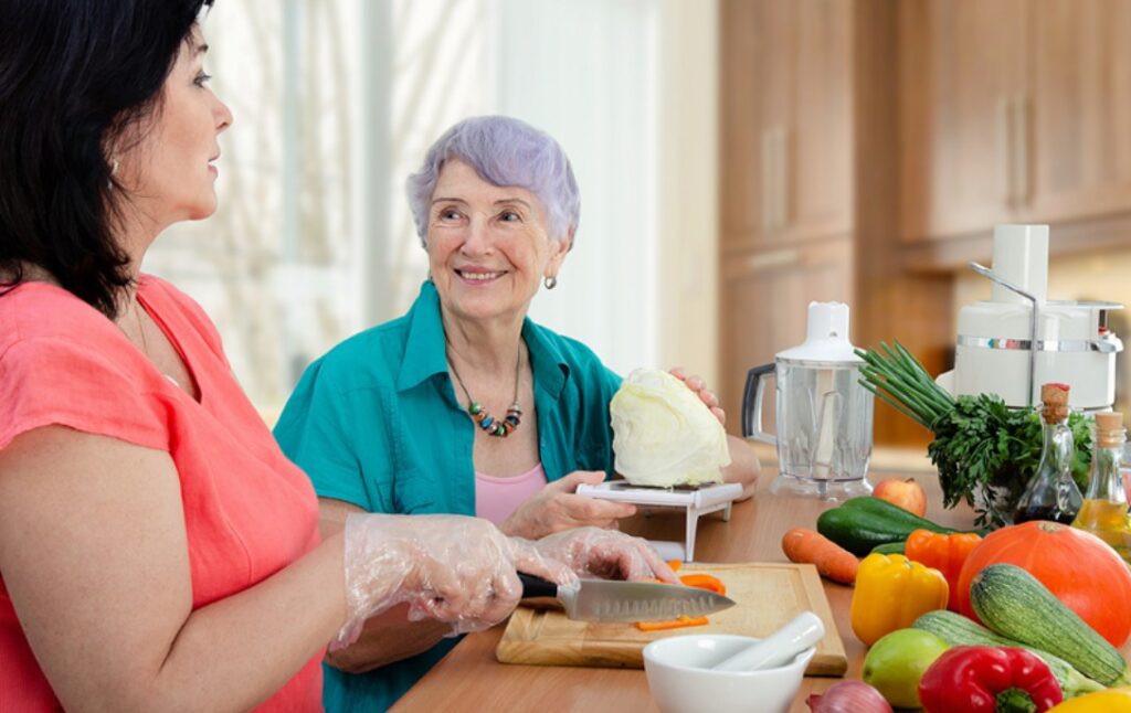 home health aide preparing meals for a patient suffering from Alzheimer's disease and providing in home care